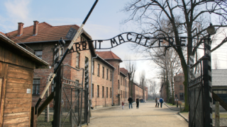 CAPTION: Arbeit Macht Frei (Work Liberates) Sign at the gate of Poland's Auschwitz Concentration Camp/Bigstock.