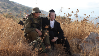 CAPTION: Israeli soldiers of the IDF Nahal Haredi unit seen at the Peles Military Base, in the Northern Jordan valley. Photo by Yaakov Naumi/Flash90.