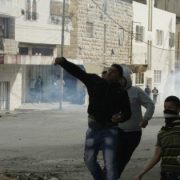 Palestinian protesters throw stones during clashes with Israeli security in the West bank town of Hebron, following the Muslim Friday noon prayers on November 21, 2014. Photo by Ibrahim Hmouz/FLASH90