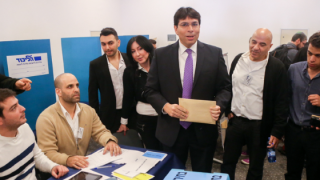 Likud MK Danny Danon (center)casts his ballot during the Likud primaries on December 31, 2014. Photo: Flash90.
