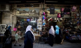 Arab women wearing hijab walk by a shop in the Muslim Quarter of Jerusalem's Old City. November 09, 2014. Photo: Miriam Alster/FLASH90
