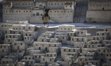 A crow stands on a model of Jerusalem in the Second Temple Period, on display at the Israel Museum in Jerusalem, on June 23, 2015. Photo by Hadas Parush/Flash90